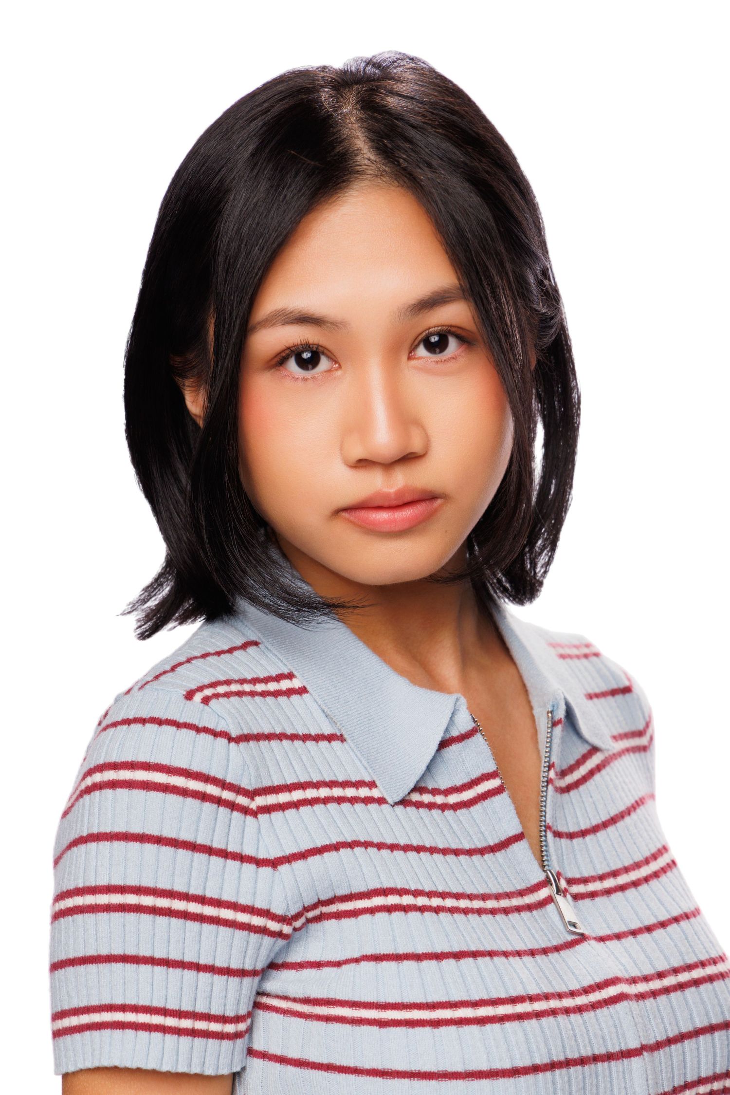 Young Asian woman with short black hair wearing a striped polo shirt, posing for a portrait on white background.