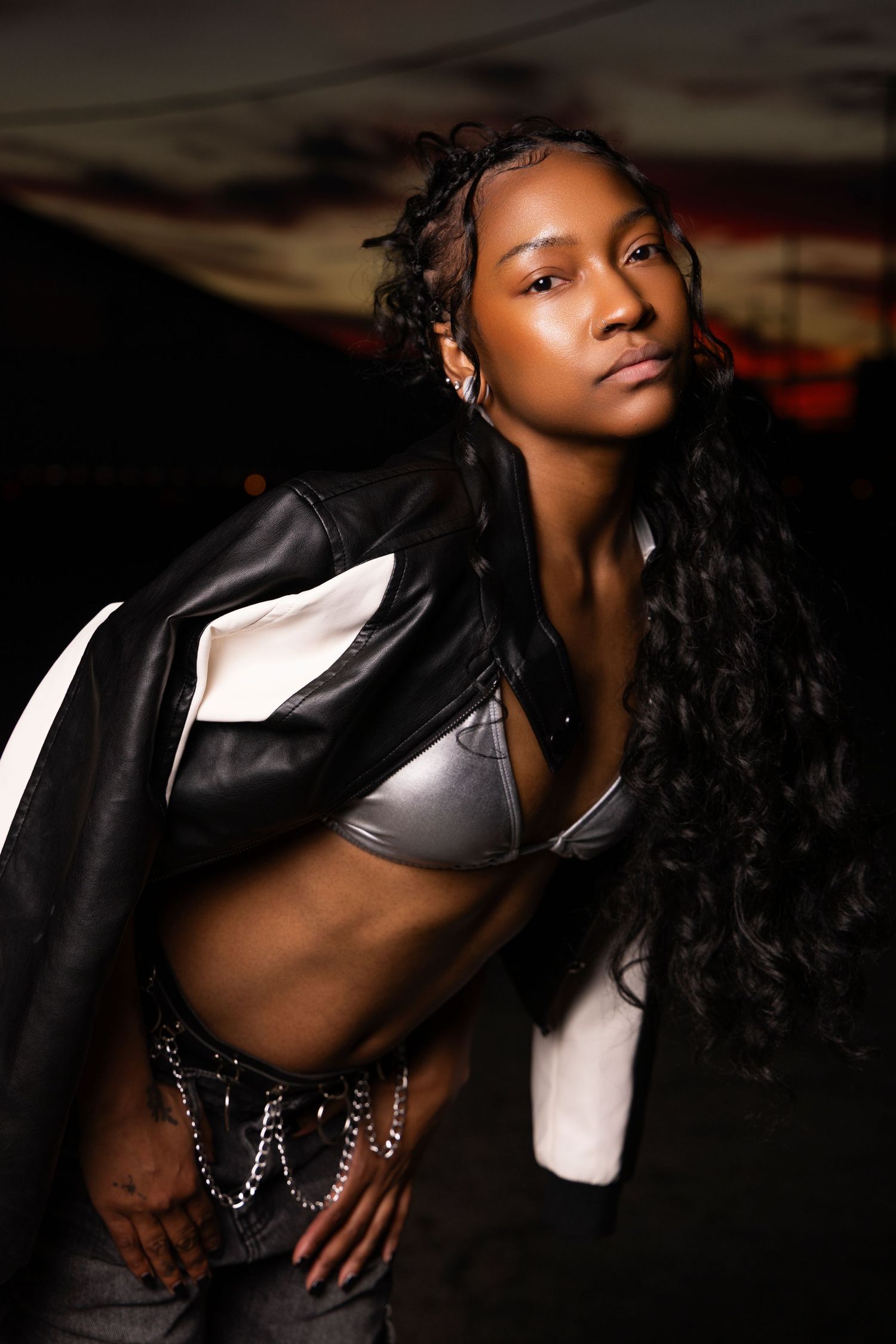 Artistic fashion portrait series showing dramatic poses in black leather jacket against dark background.