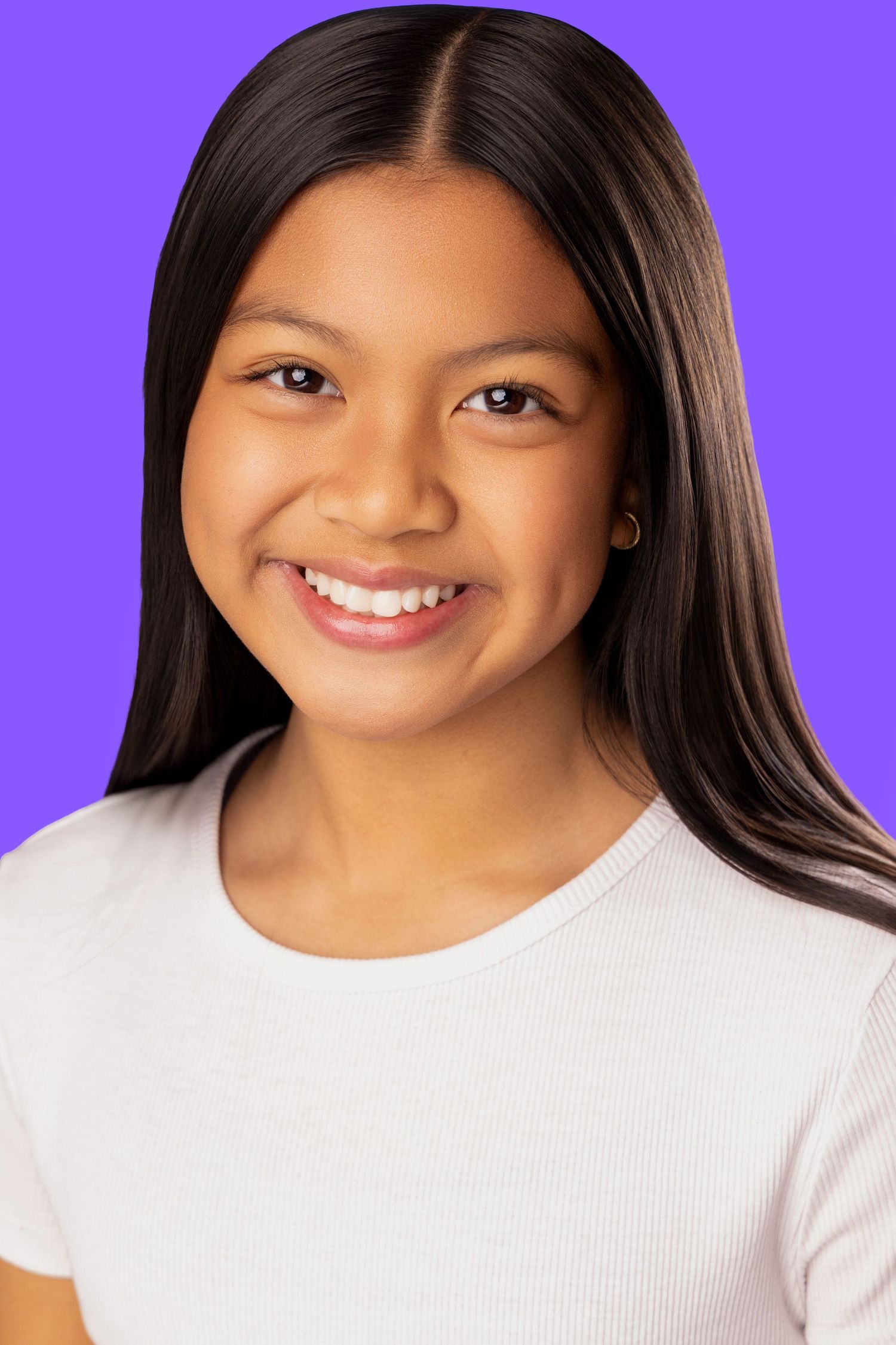 Portrait of a young Asian model with long black hair wearing a white t-shirt against a purple background.