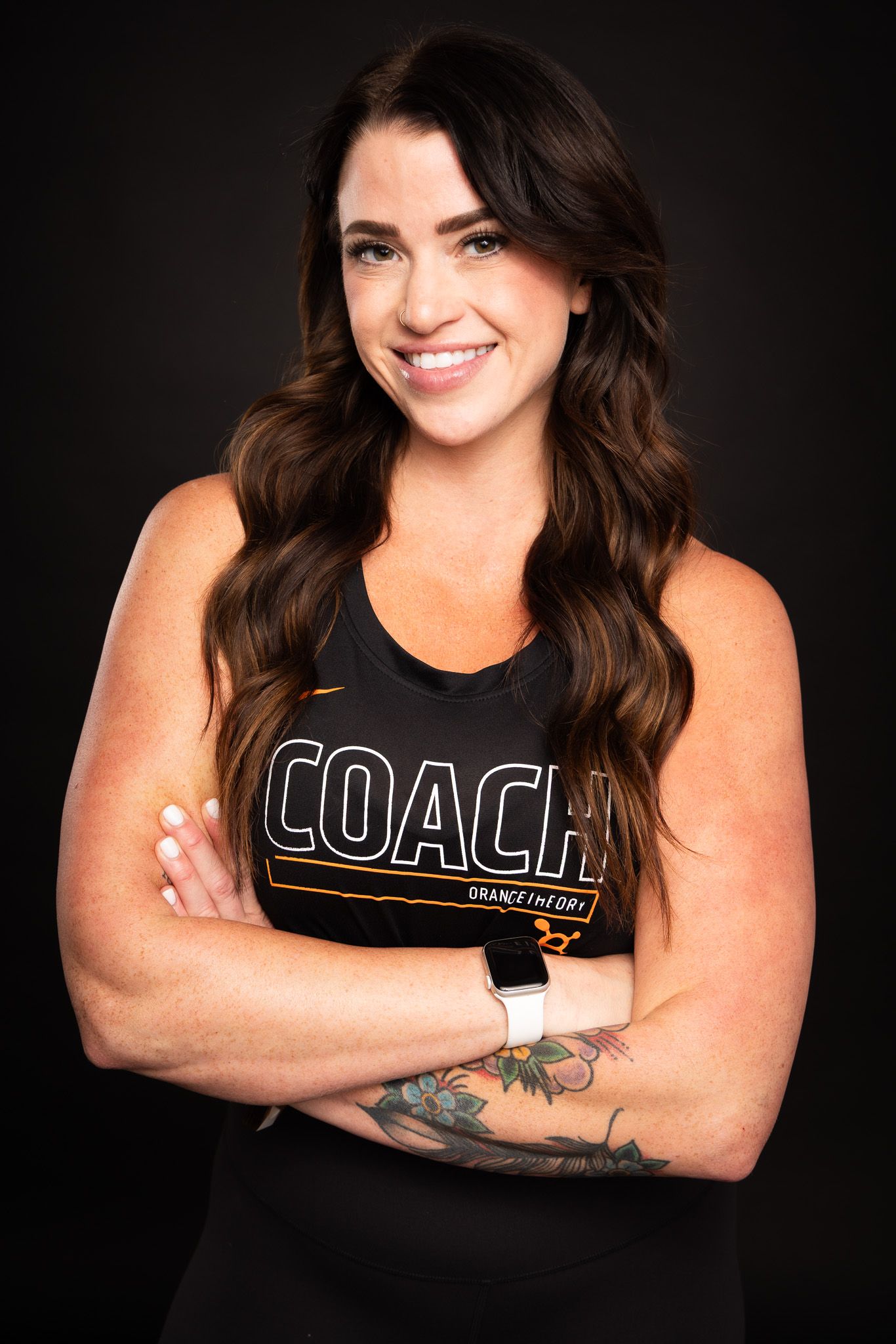 Professional studio portraits of someone in a Coach branded tank top against dark backdrop with various poses.