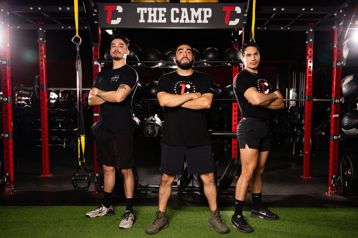 Athletes perform lunges during a high-intensity workout session at The Camp fitness facility.