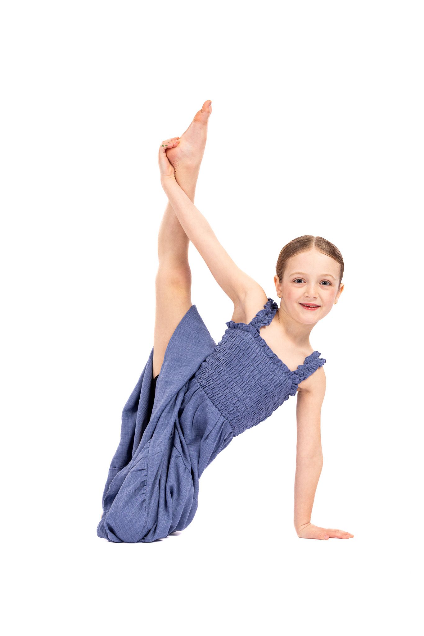 Young gymnast in blue performing a cartwheel sequence on white background showing progressive movement stages.