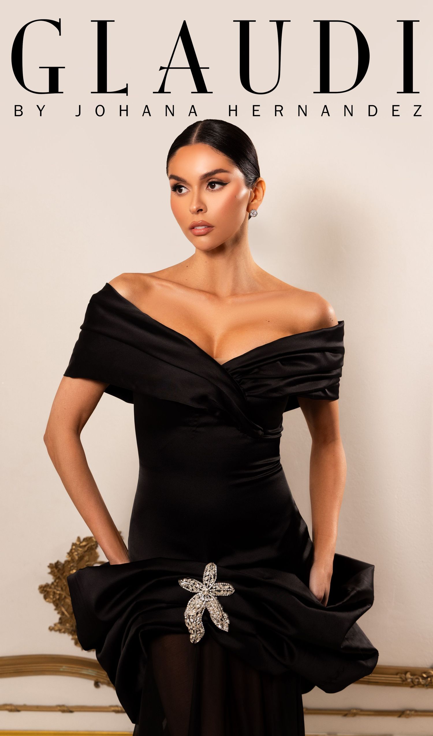 Model wearing an elegant black off-shoulder gown with crystal brooch by Glaudi by Johana Hernandez.