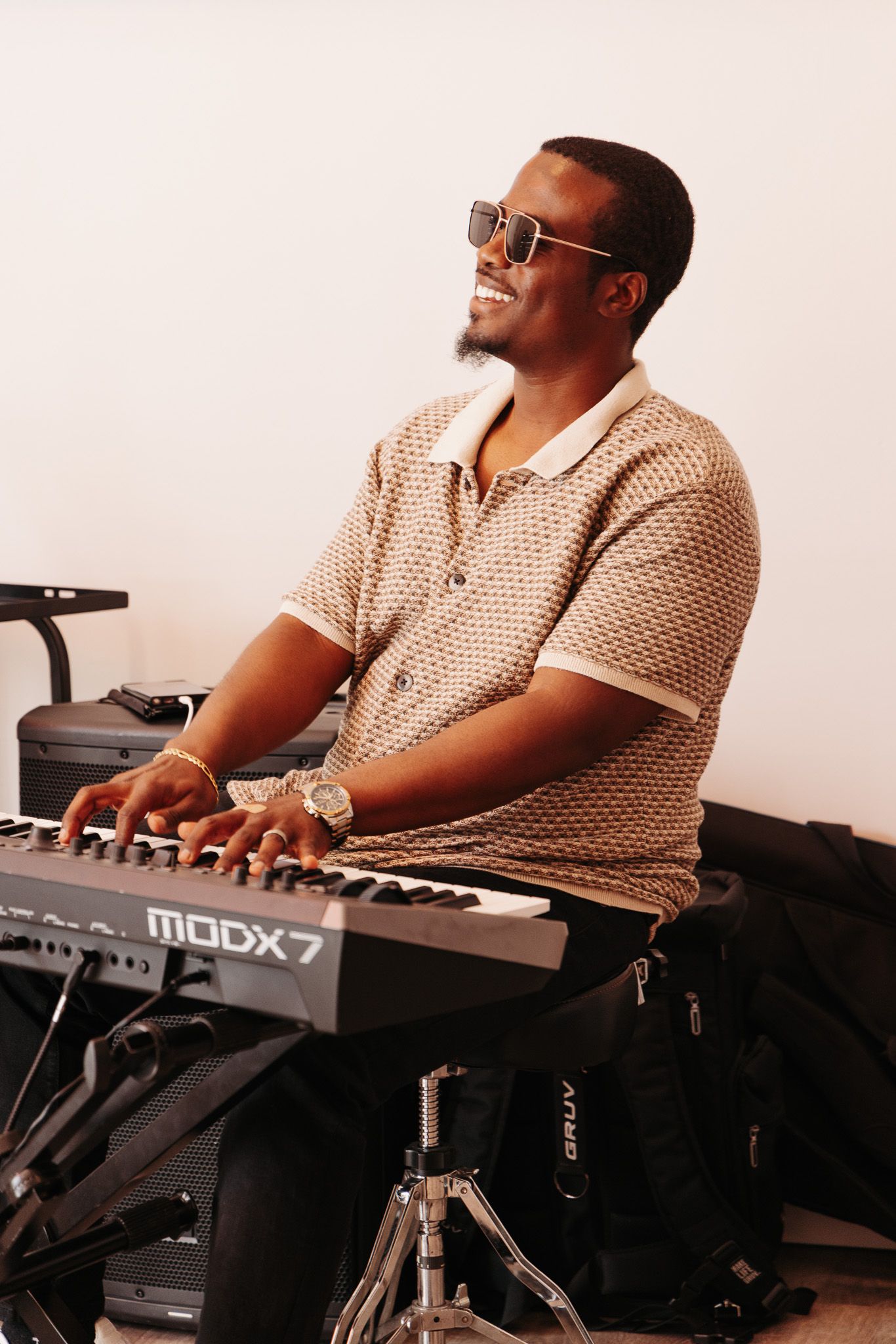 A musician performs passionately on a keyboard synthesizer during a live music session.
