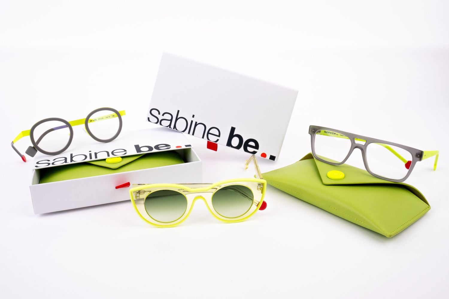 Seamless collection progression showing four pairs of lime green and white eyeglass frames displayed on a white background.