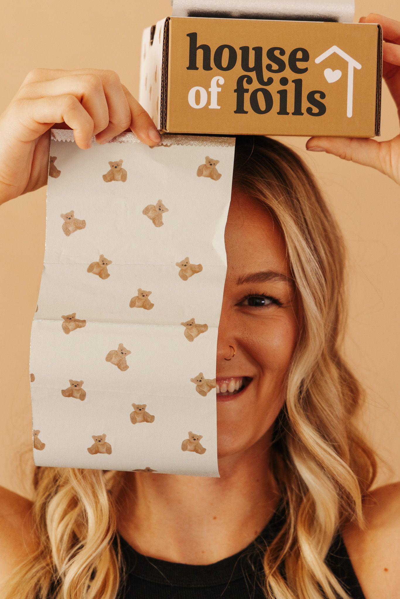 A collage of cropped photos showing a person smiling and holding paper with foil branding mockups against beige background.