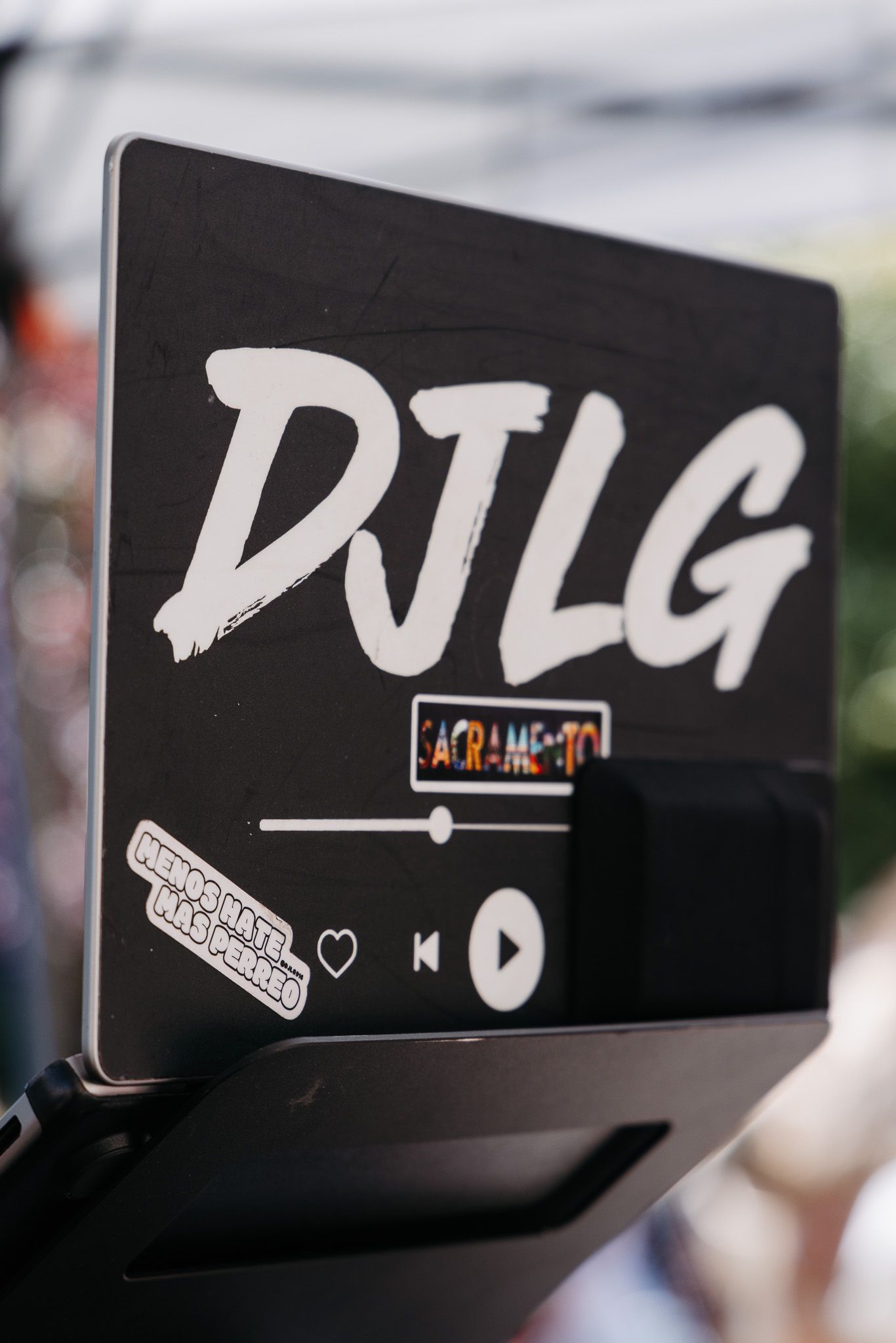 A black DJ equipment display showing 'DJLG' text and media controls.