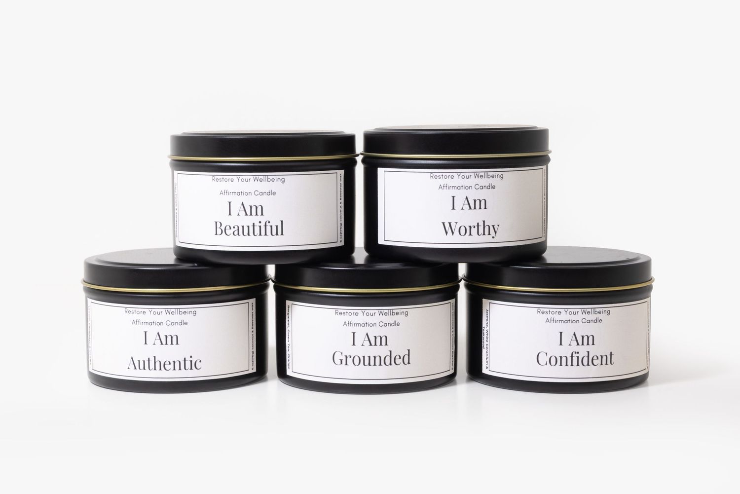 Five black tin candles with affirmation labels: I Am Beautiful, Worthy, Authentic, Grounded, and Confident.