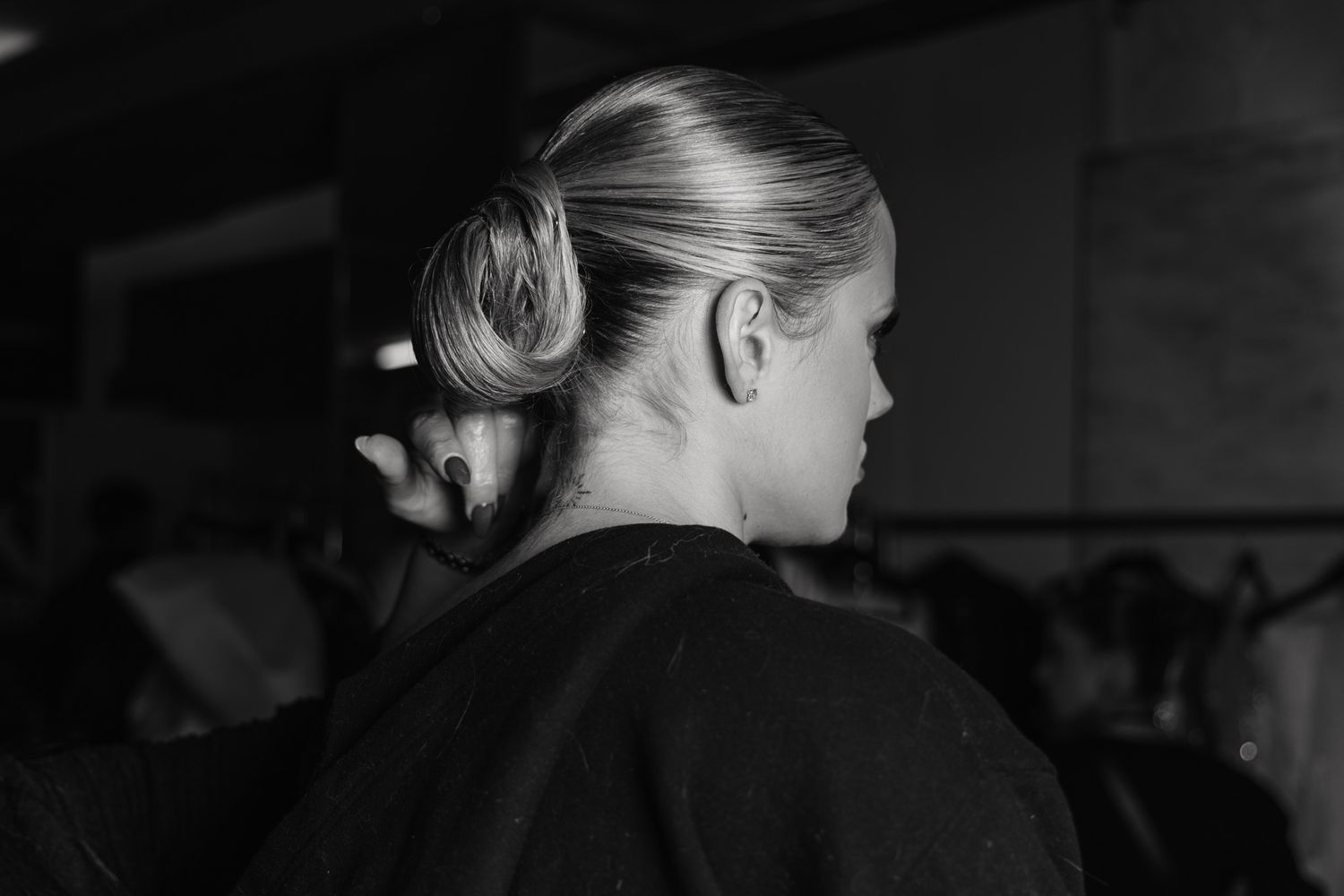 Black and white profile view of wedding guests in formal attire.