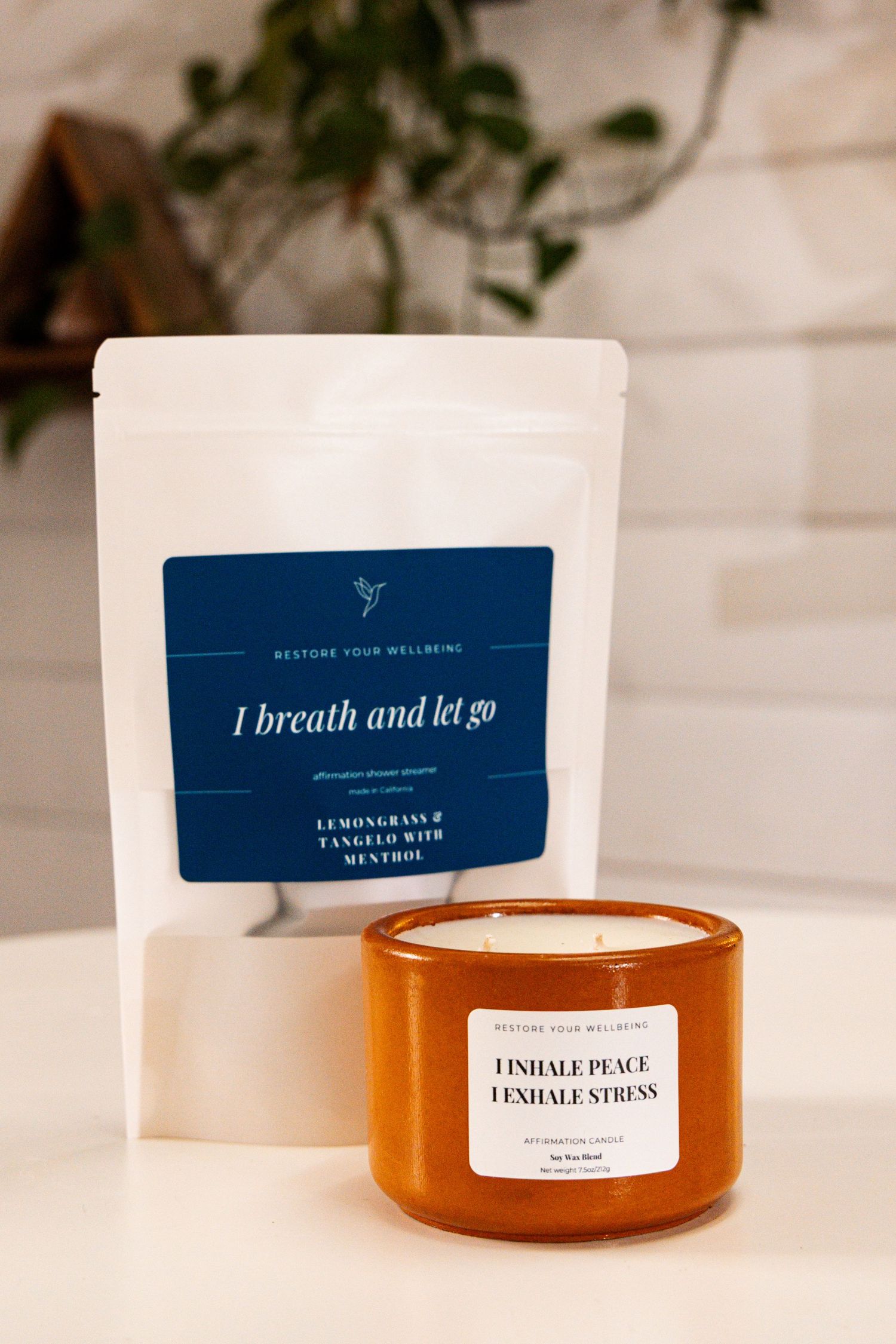 A series of amber glass candles with minimalist navy blue and white labels displaying calming wellness-focused text.