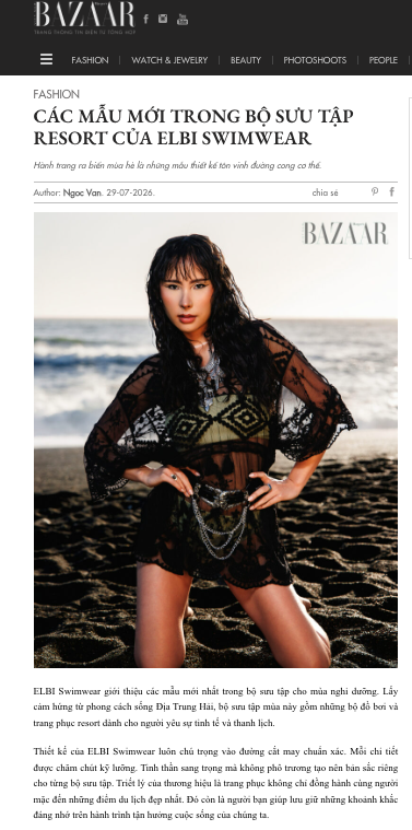 Model poses on rocky beach in ELBI Swimwear Resort collection sheer coverup and bikini, featured in Harper's Bazaar Vietnam.