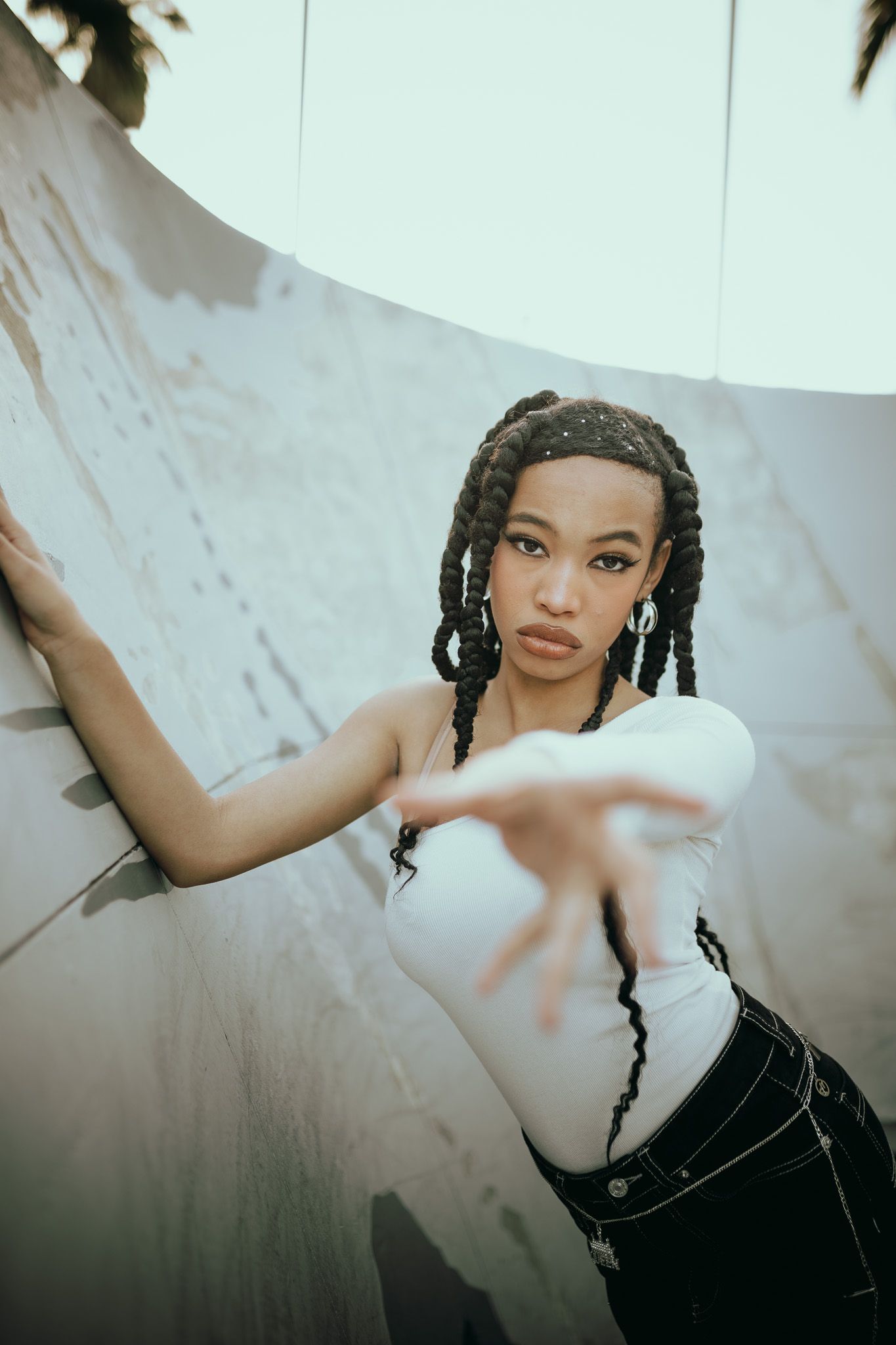 Artistic fashion portraits shot at unique angles against a minimalist white backdrop.