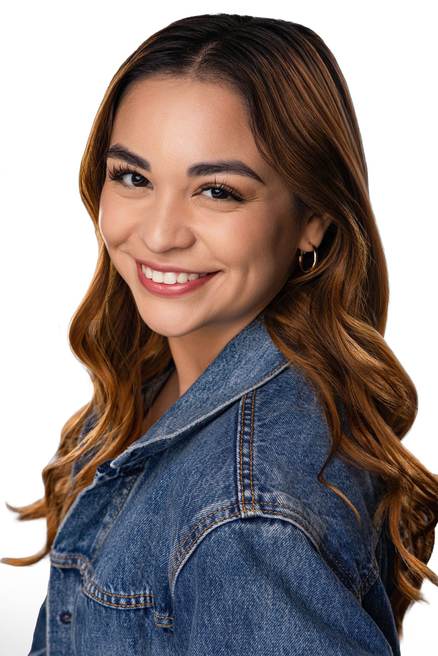 Three headshots showing a smiling woman with wavy brown hair wearing a denim jacket against a light background.