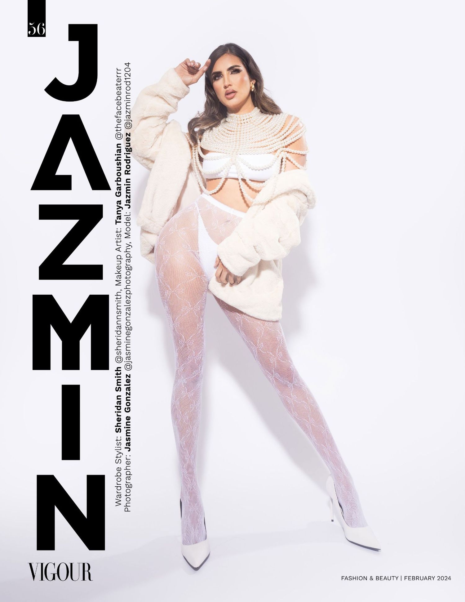 Fashion model in oversized cream sweater and patterned tights poses against white backdrop for magazine cover.