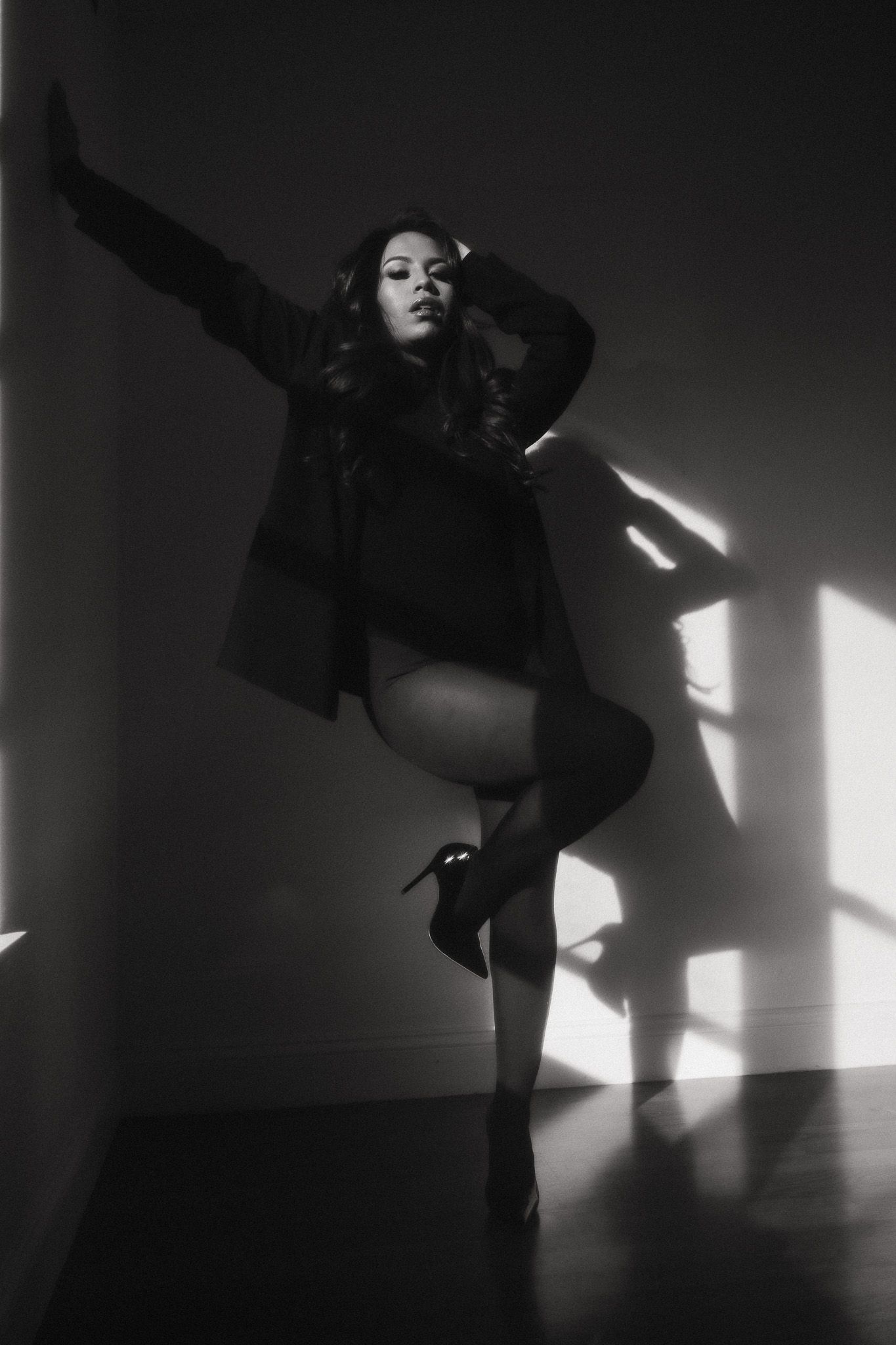 Black and white artistic photo series showing dramatic shadows and silhouettes moving in contrasting light and darkness.