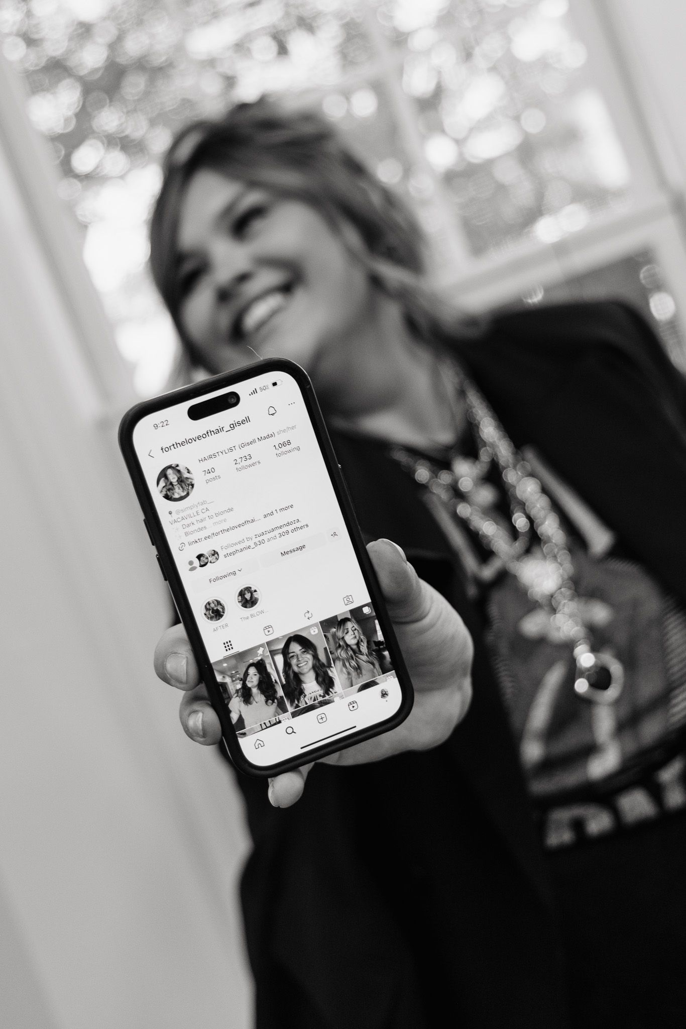 Black and white photo series showing a mobile phone displaying social media content while being held up.