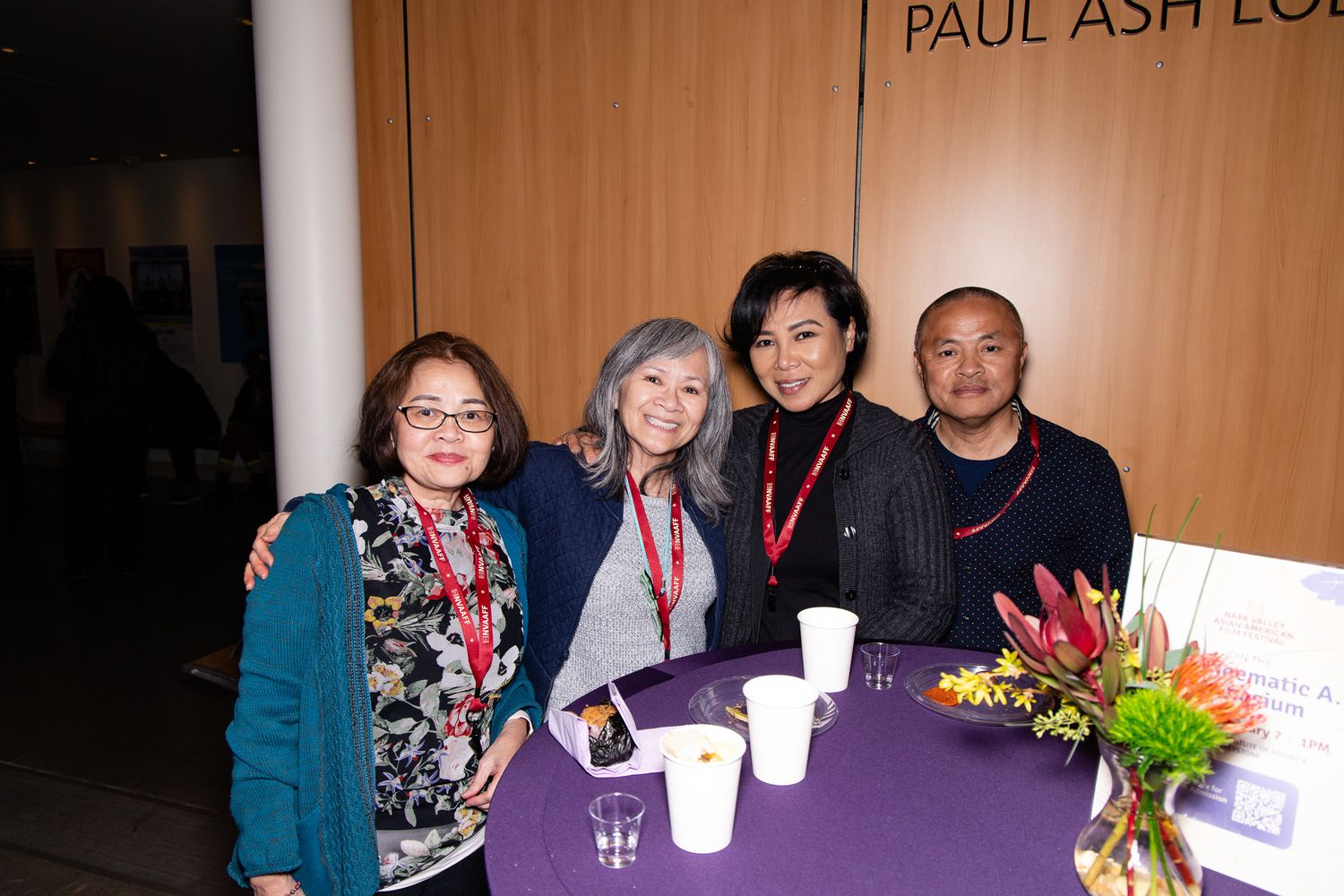 Small group gathered around a table at what appears to be a film festival event.