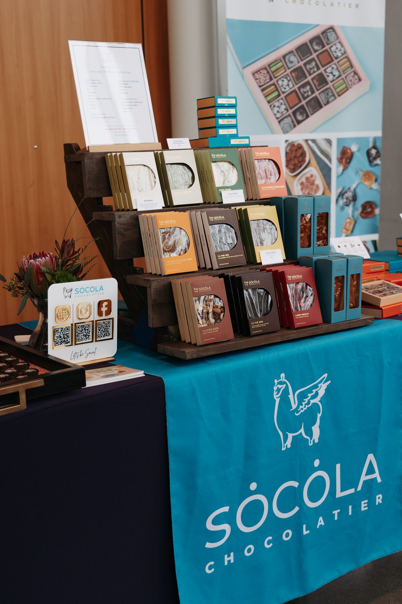 Socola Chocolatier display booth featuring artisanal chocolate products and branded merchandise.