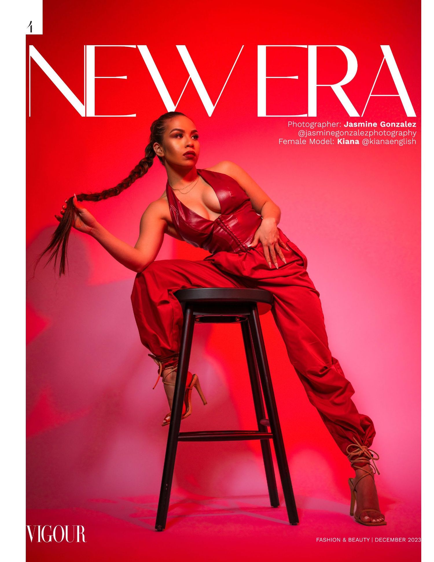 Model in red dress poses on black stool against vibrant pink backdrop for fashion editorial.