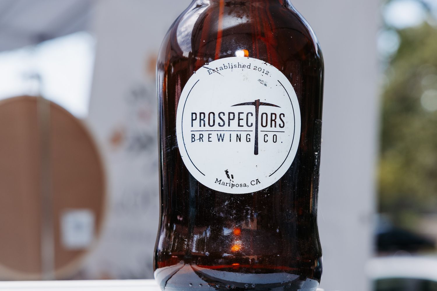 Dark amber glass growler bottle with Prospectors Brewing Co. label, established in Hangtown, CA.