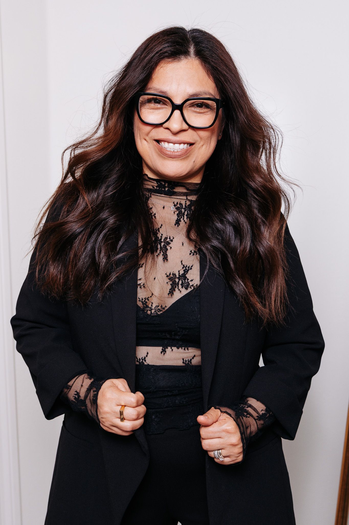 Series of dynamic headshots showing a woman in black blazer and glasses with a cheerful expression.