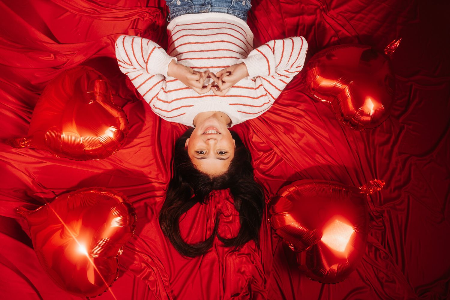 Red-tinted photo montage shows a person dancing with LED light trails creating ethereal patterns and glowing effects.