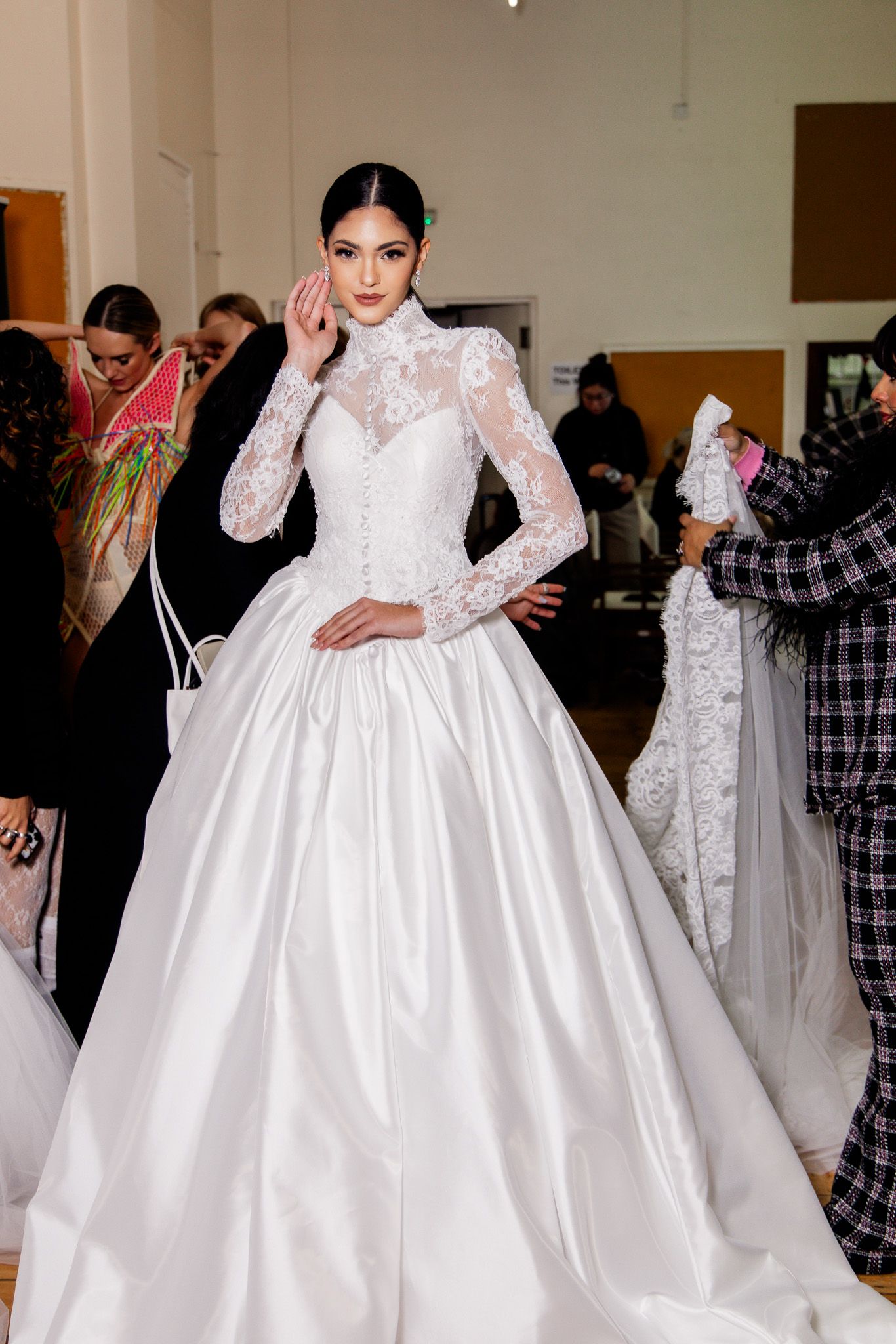 Elegant white ball gown wedding dress with long lace sleeves and full skirt shown in multiple fitting angles.
