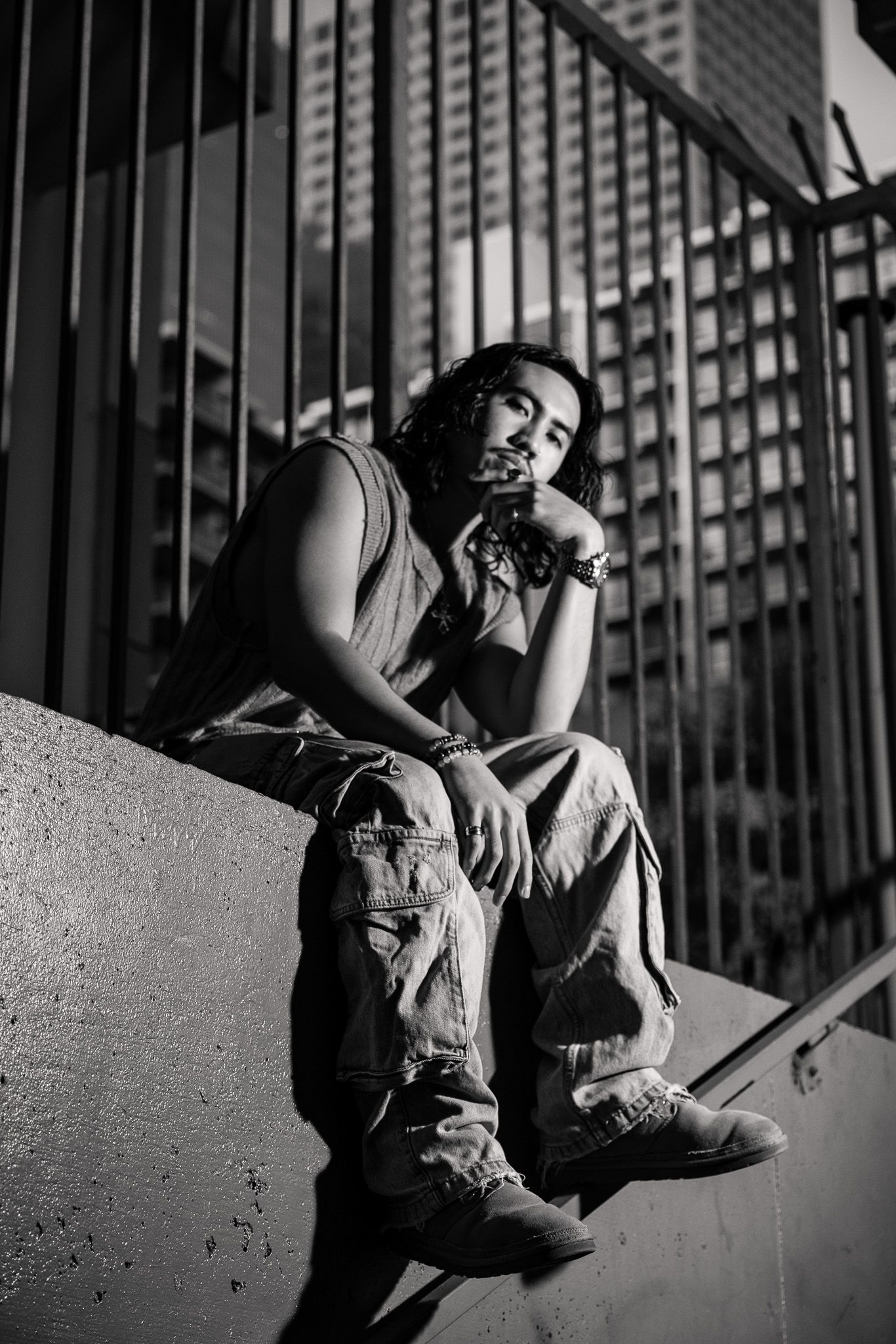 Black and white photo series showing dramatic dance movements against an urban backdrop with metal bars.