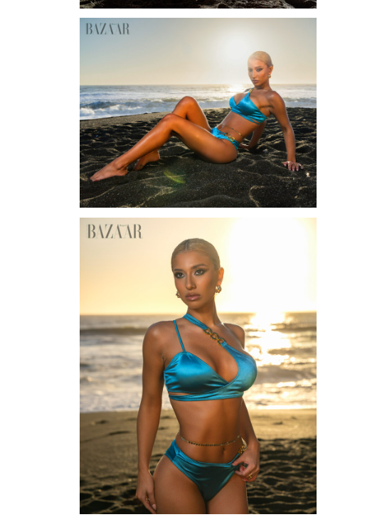 Model poses in teal blue bikini on rocky beach for Harper's Bazaar, with ocean waves in background.