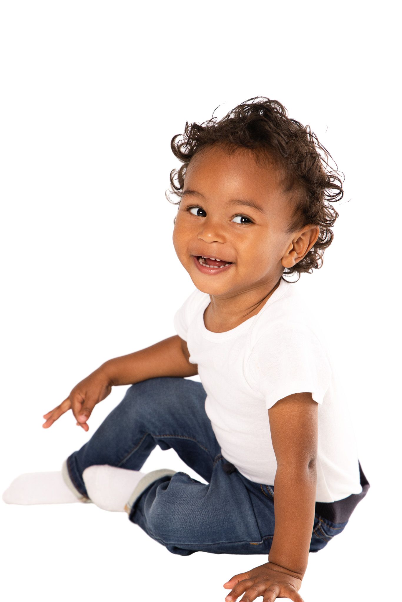 A playful toddler in white t-shirt and jeans crawls and moves across a white background in multiple poses.
