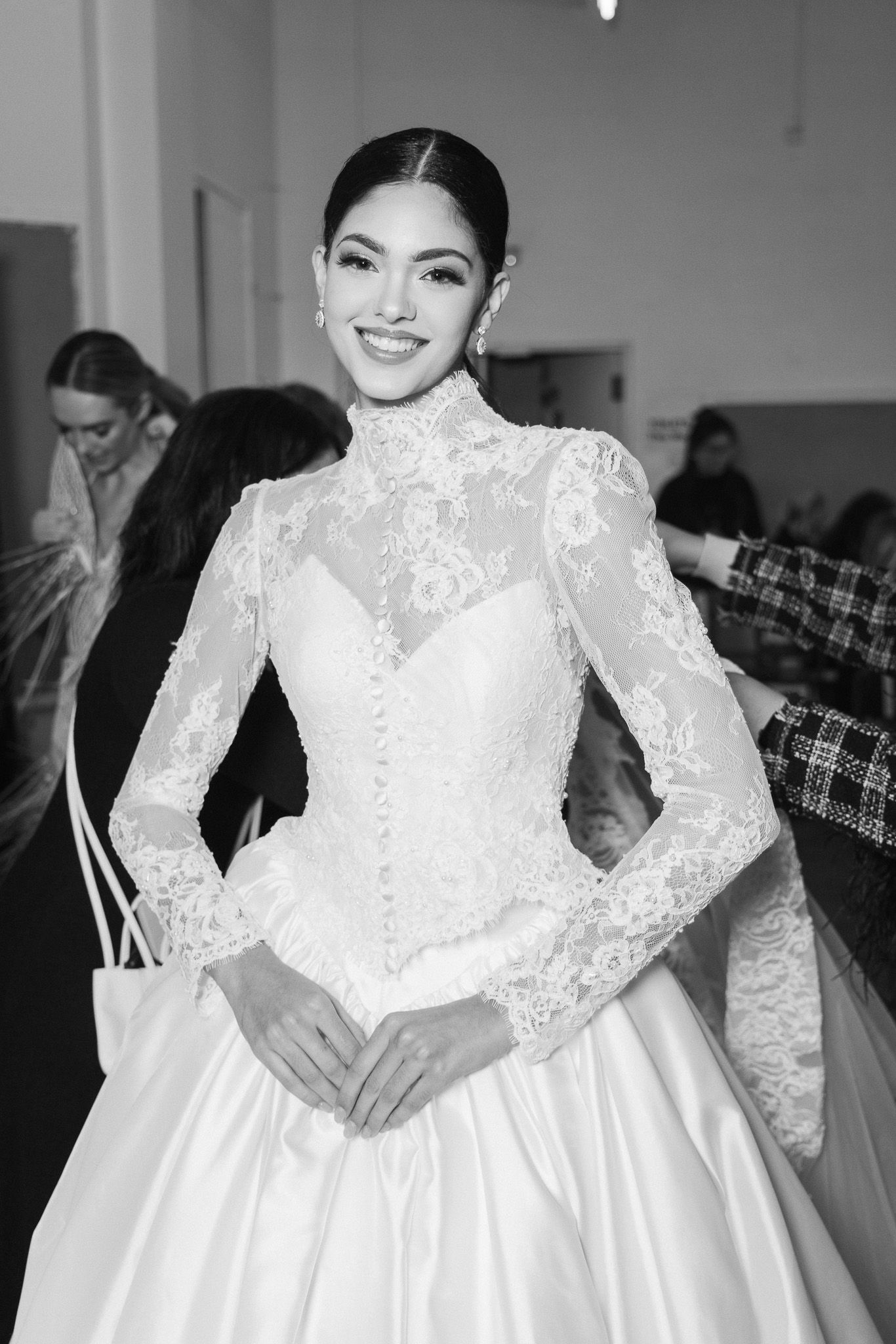 Elegant long-sleeve lace wedding dress with fitted bodice and full skirt in classic silhouette.