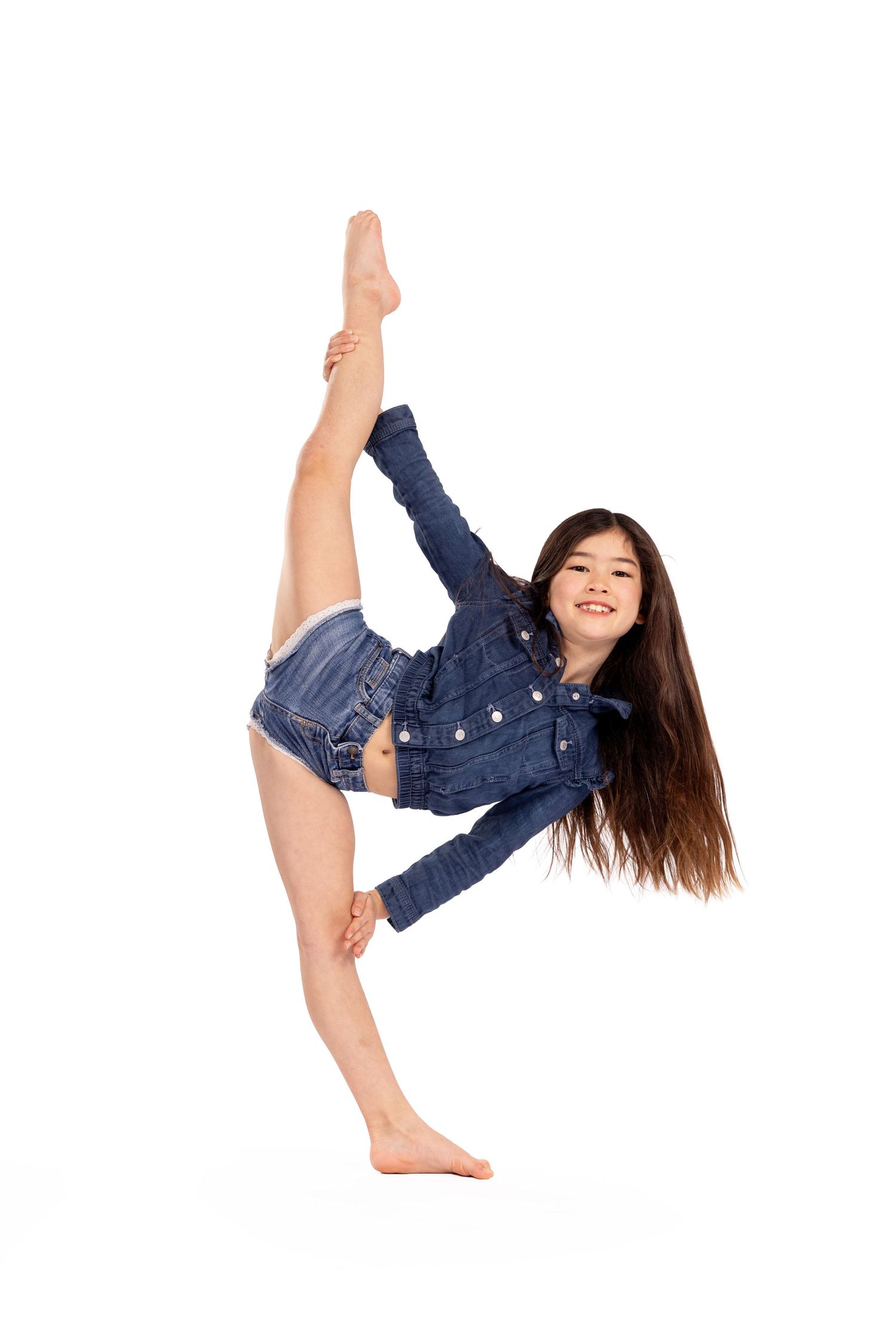 A dancer in denim demonstrates dynamic movement poses in a studio setting.