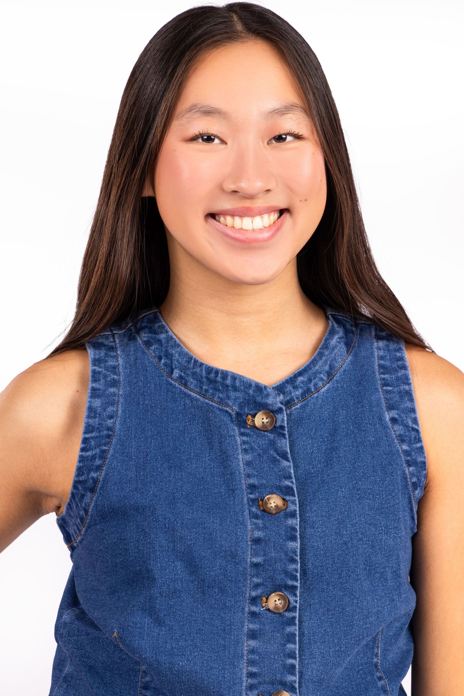 Four cropped headshots showing someone wearing a sleeveless denim button-up top with a bright smile.