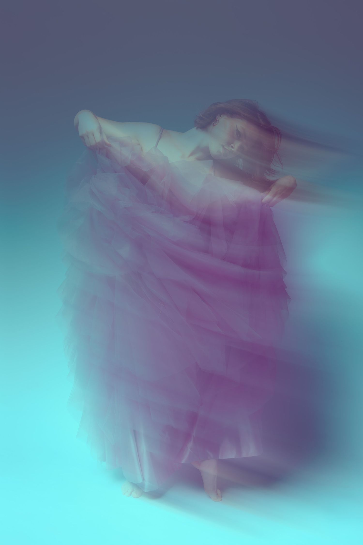 Abstract purple and turquoise smoke swirls create an ethereal gradient pattern against a dark background.