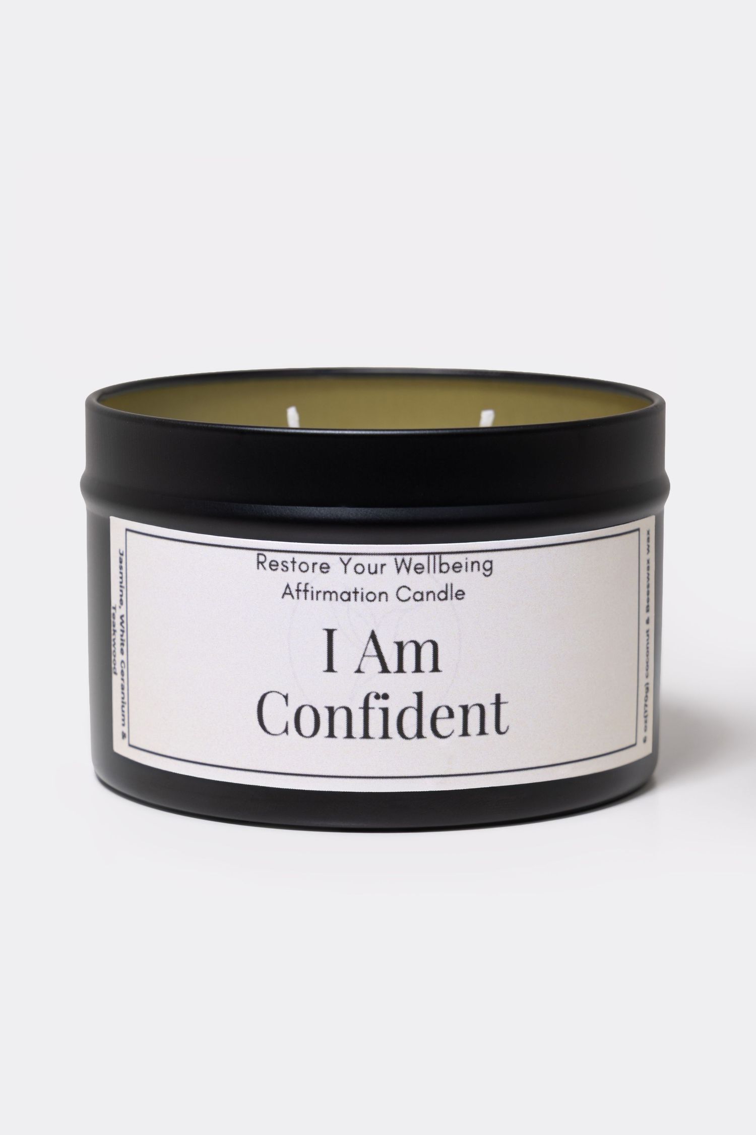 Black tin affirmation candle labeled I Am Confident by Restore Your Wellbeing, featuring a white label and two wicks.