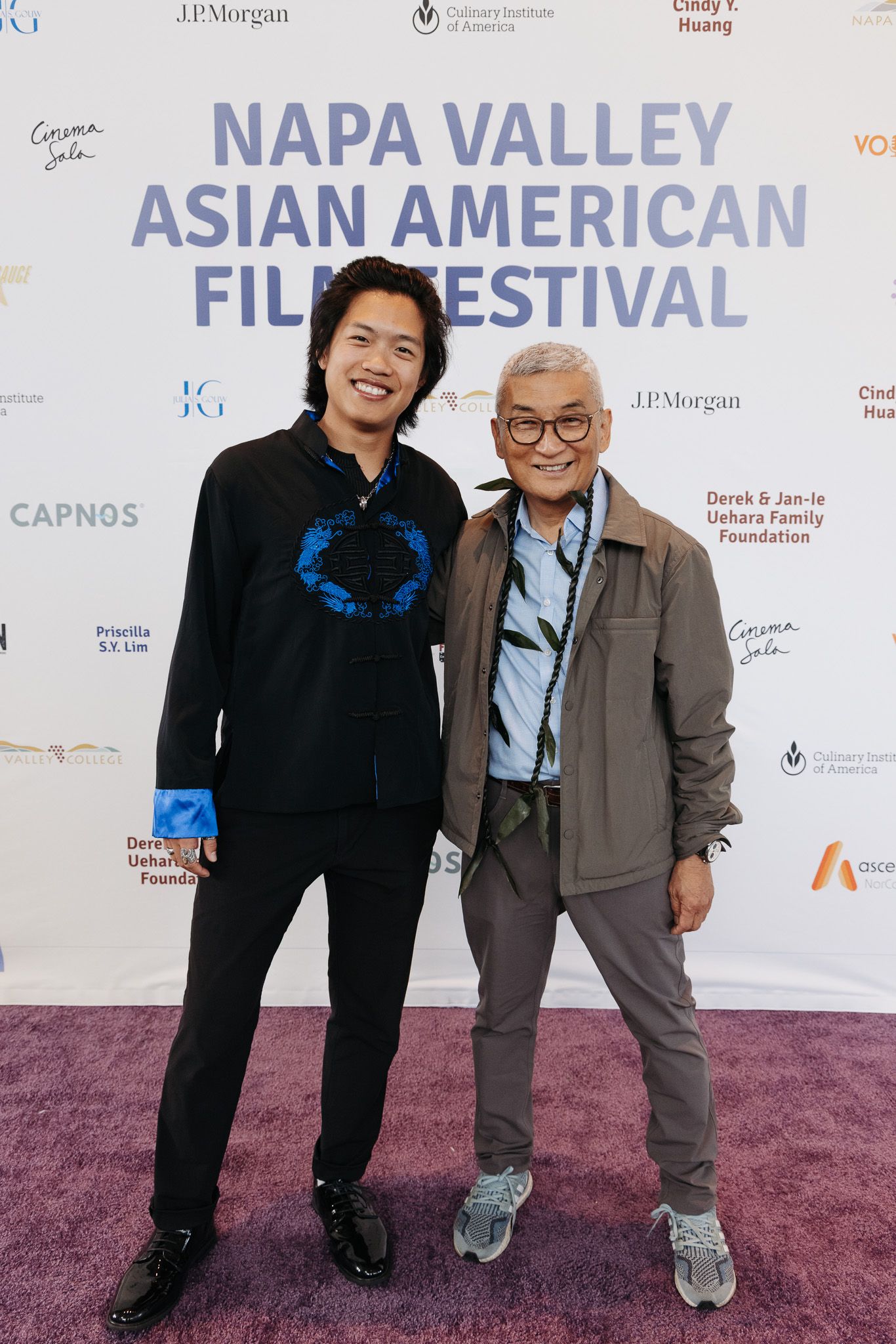 Two attendees posing together on red carpet at film festival event.