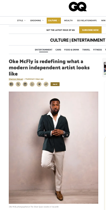Oke McFly poses confidently in a dark blazer and white trousers at The Street Space studio in Vacaville.