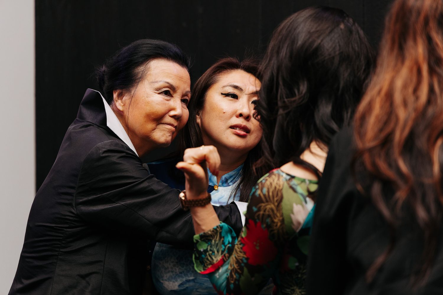 A group of people share an intimate moment during what appears to be a social gathering.