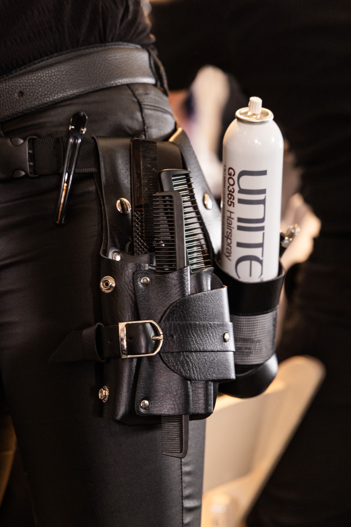 Close-up shots of a tactical utility belt showing black leather holsters and mounting attachments.