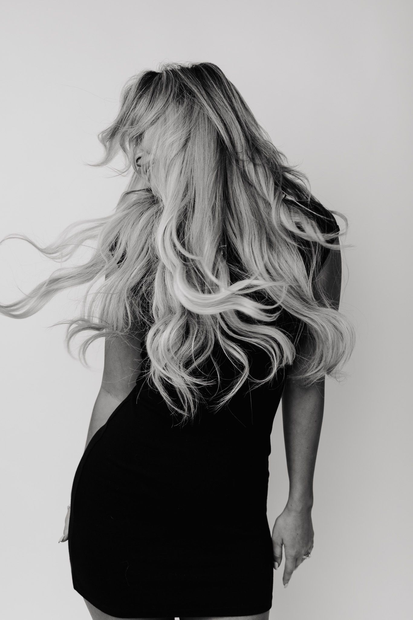Series of black and white photos showing blonde hair movement against white background.