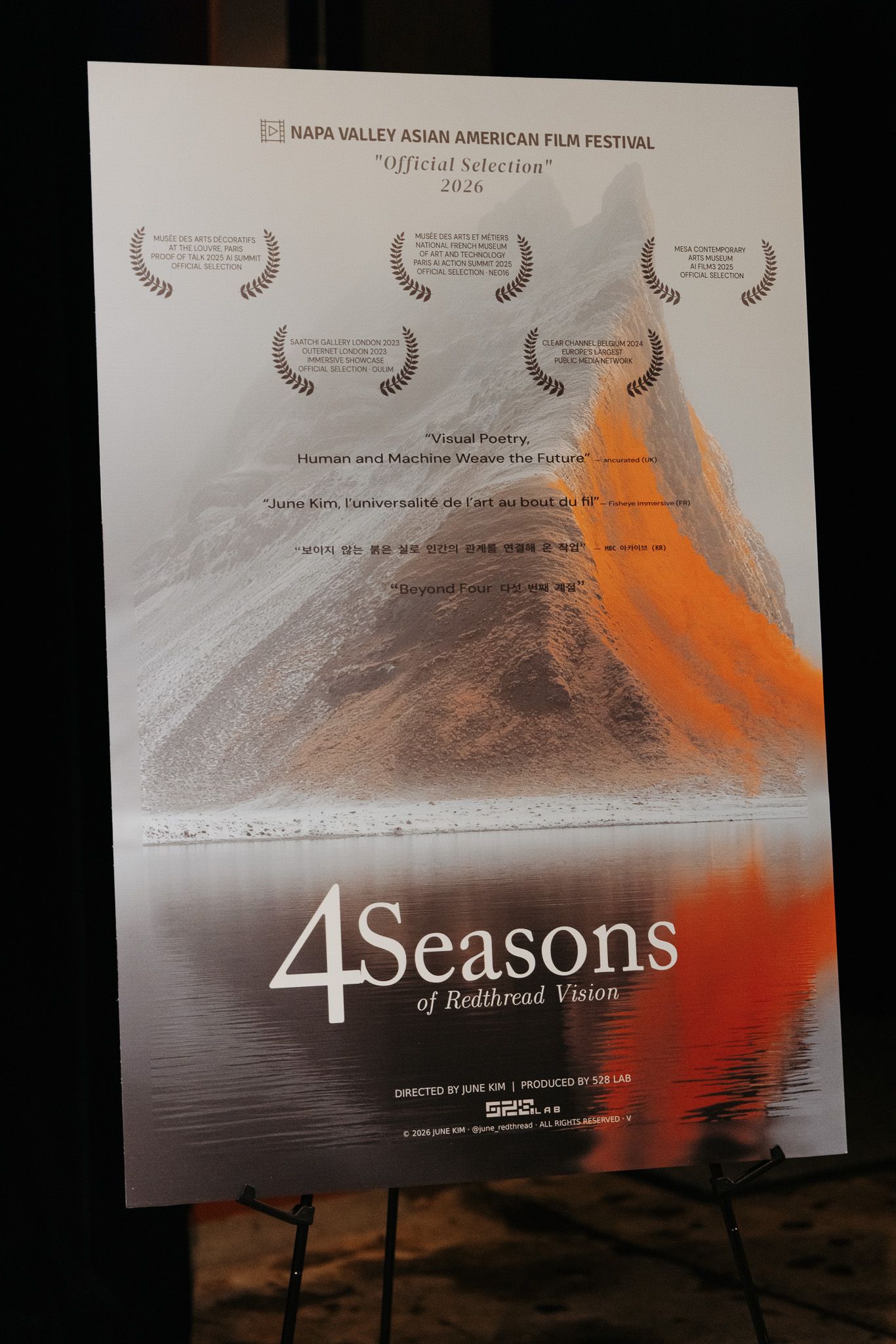 Film festival poster for '4 Seasons' showing a mountain landscape with orange accents and award laurels.