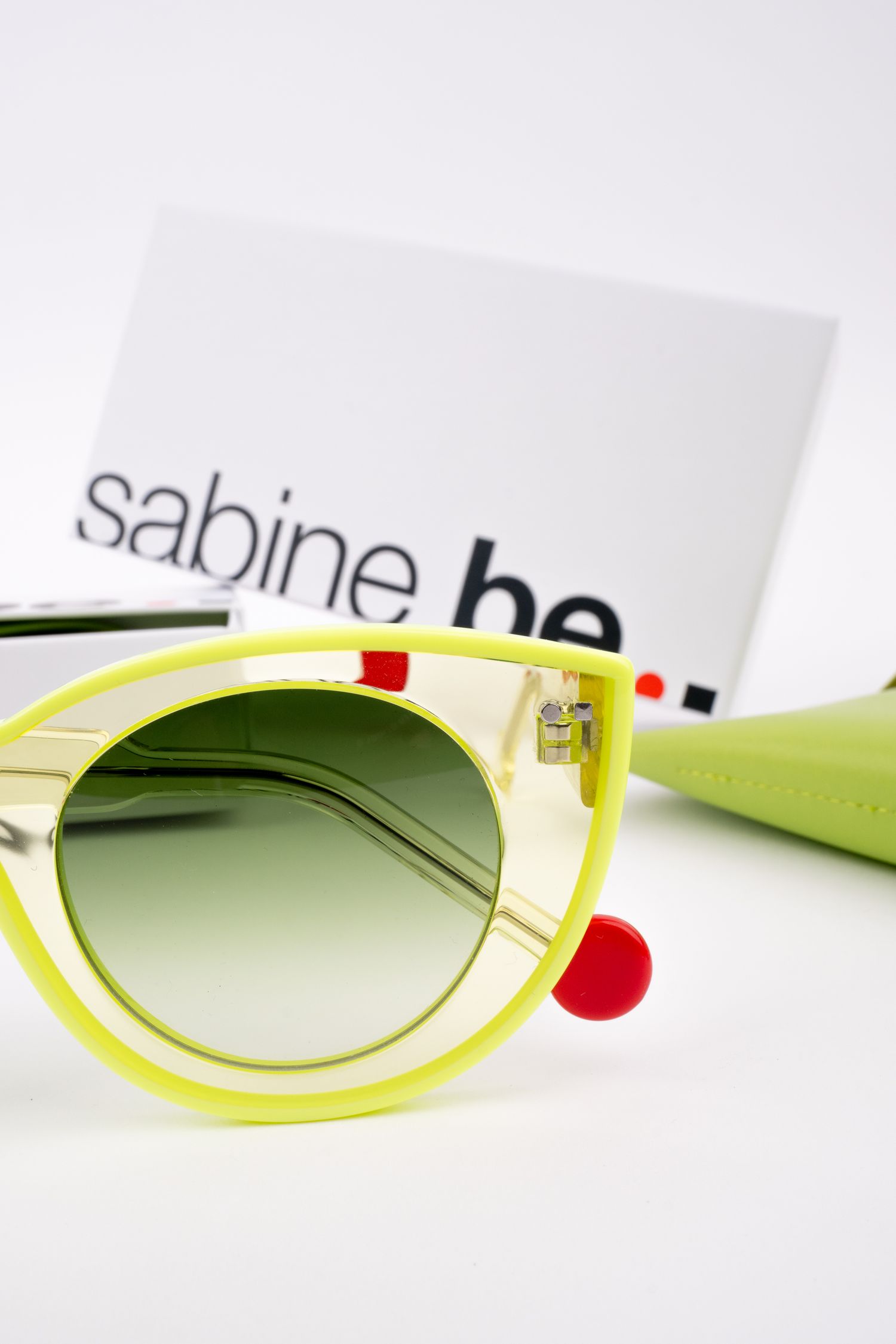 Stylish neon yellow retro sunglasses with gradient green lenses shown from different angles against white backdrop.