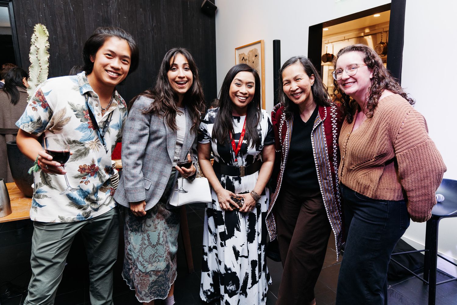 Group of attendees socializing and taking photos at film festival reception.