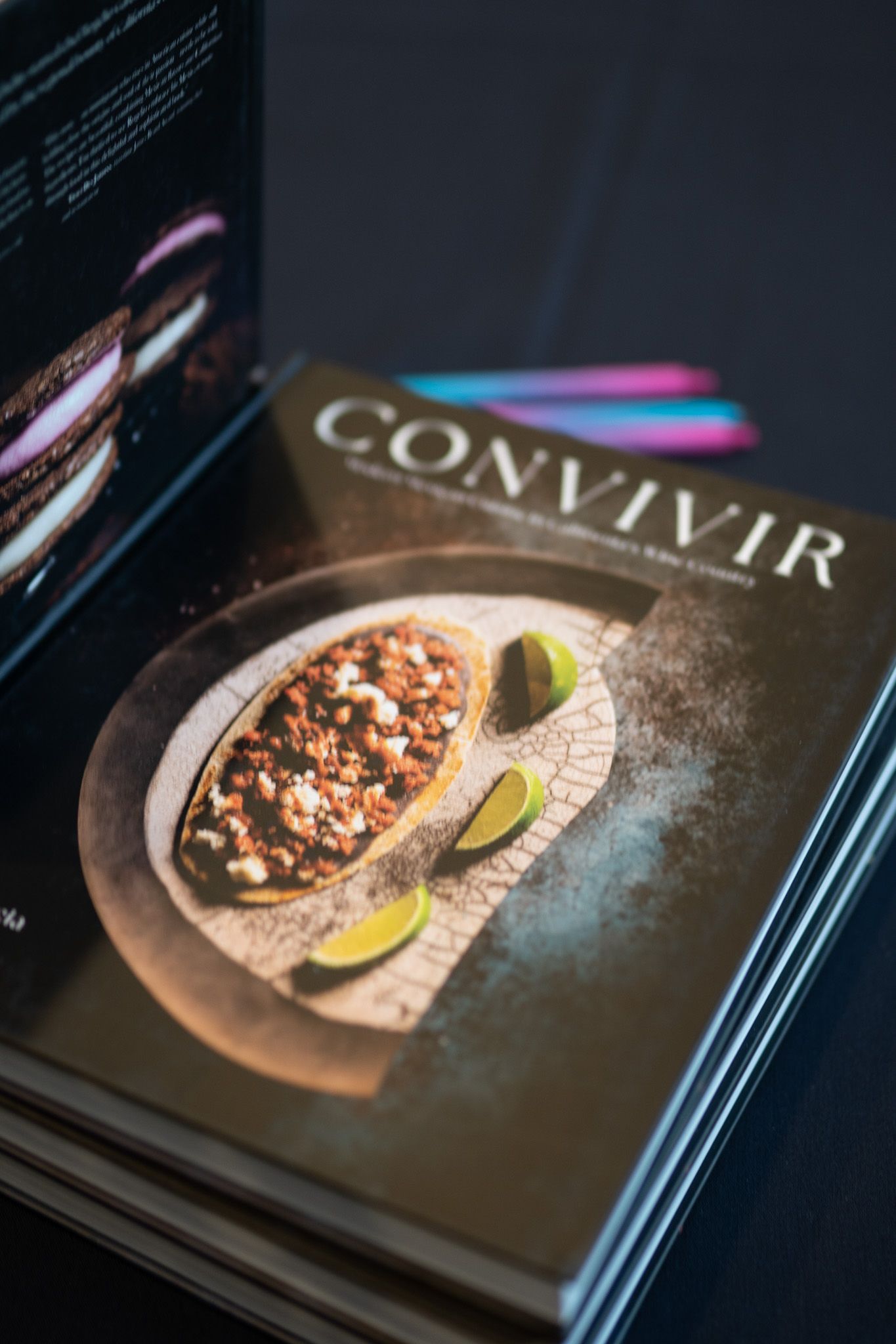 A series of closeup shots showing a dark magazine cover with a food dish and lime garnish.