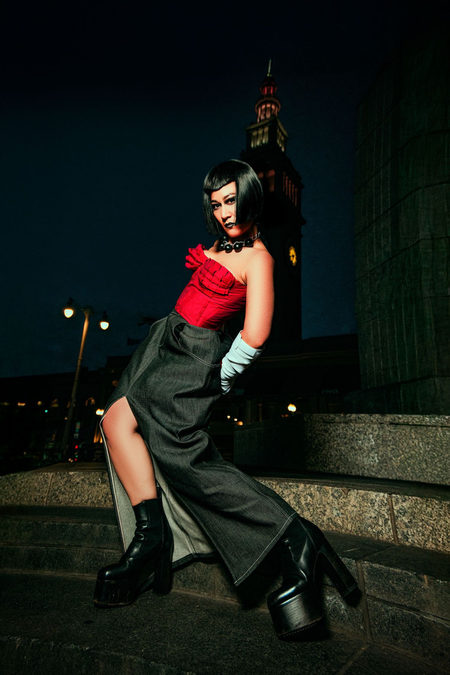 A dramatic fashion photo series showing a figure in black and red posing against a dark urban nighttime backdrop.