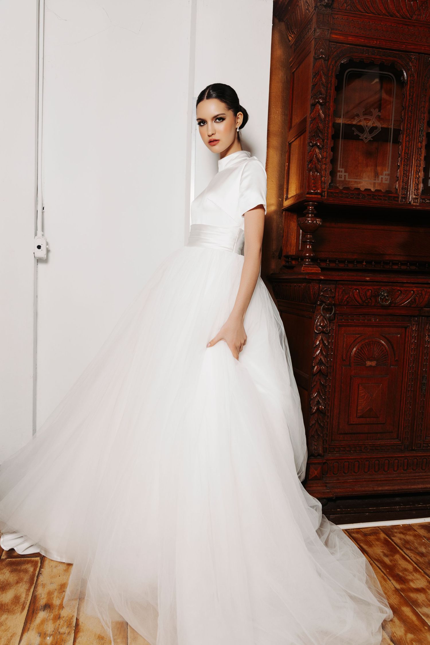 A collection of bridal portraits featuring a voluminous white tulle ball gown in an elegant indoor setting.