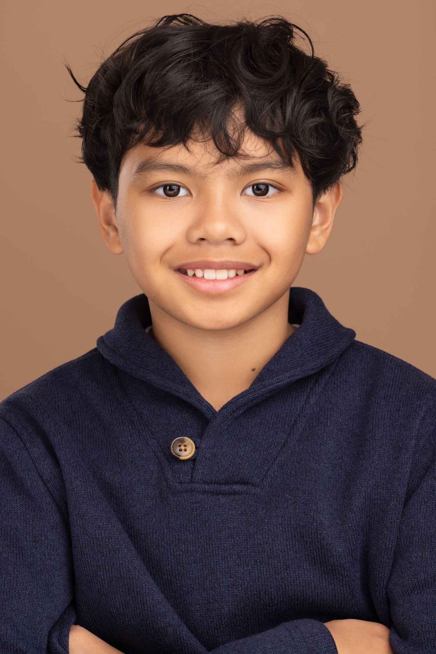 A series of headshots showing someone wearing a navy blue hoodie against a warm brown background.