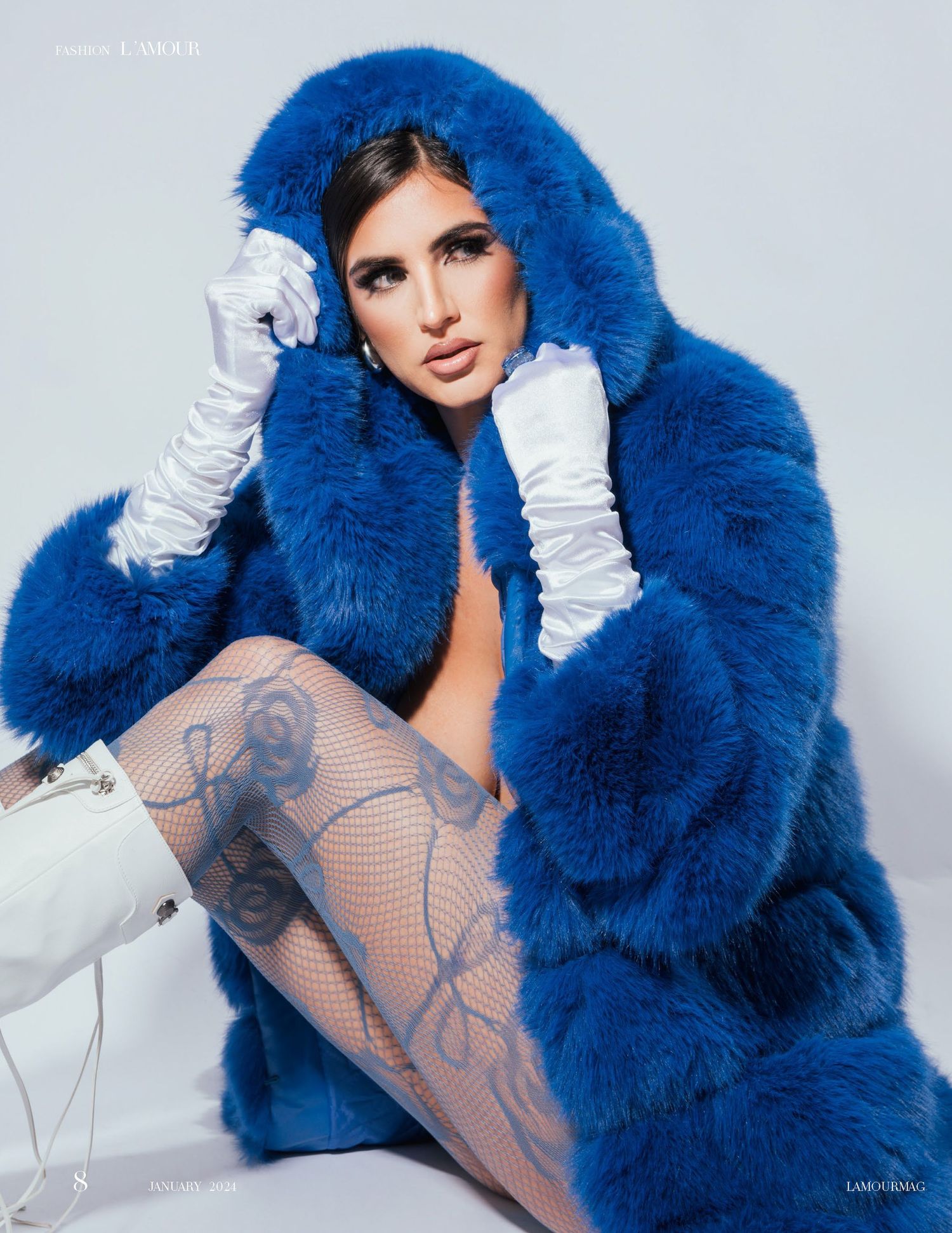 Fashion photo showcasing electric blue fur coat and patterned stockings.