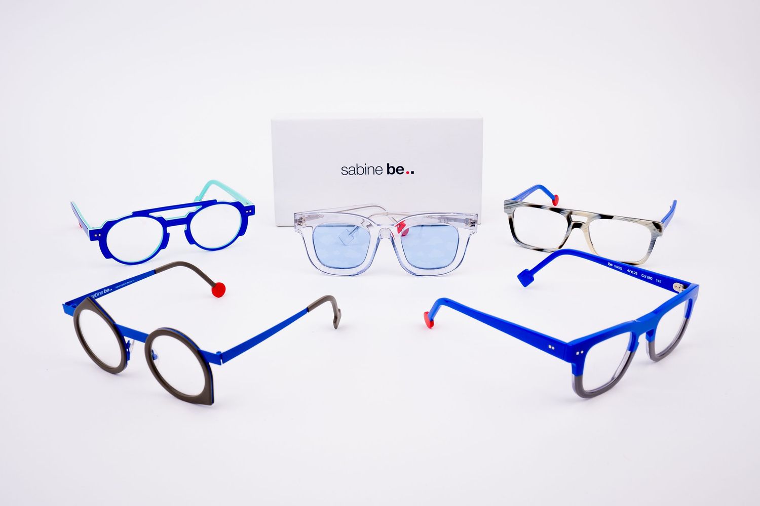 Collection of blue and black eyeglass frames displayed in a row showing different styles and designs.