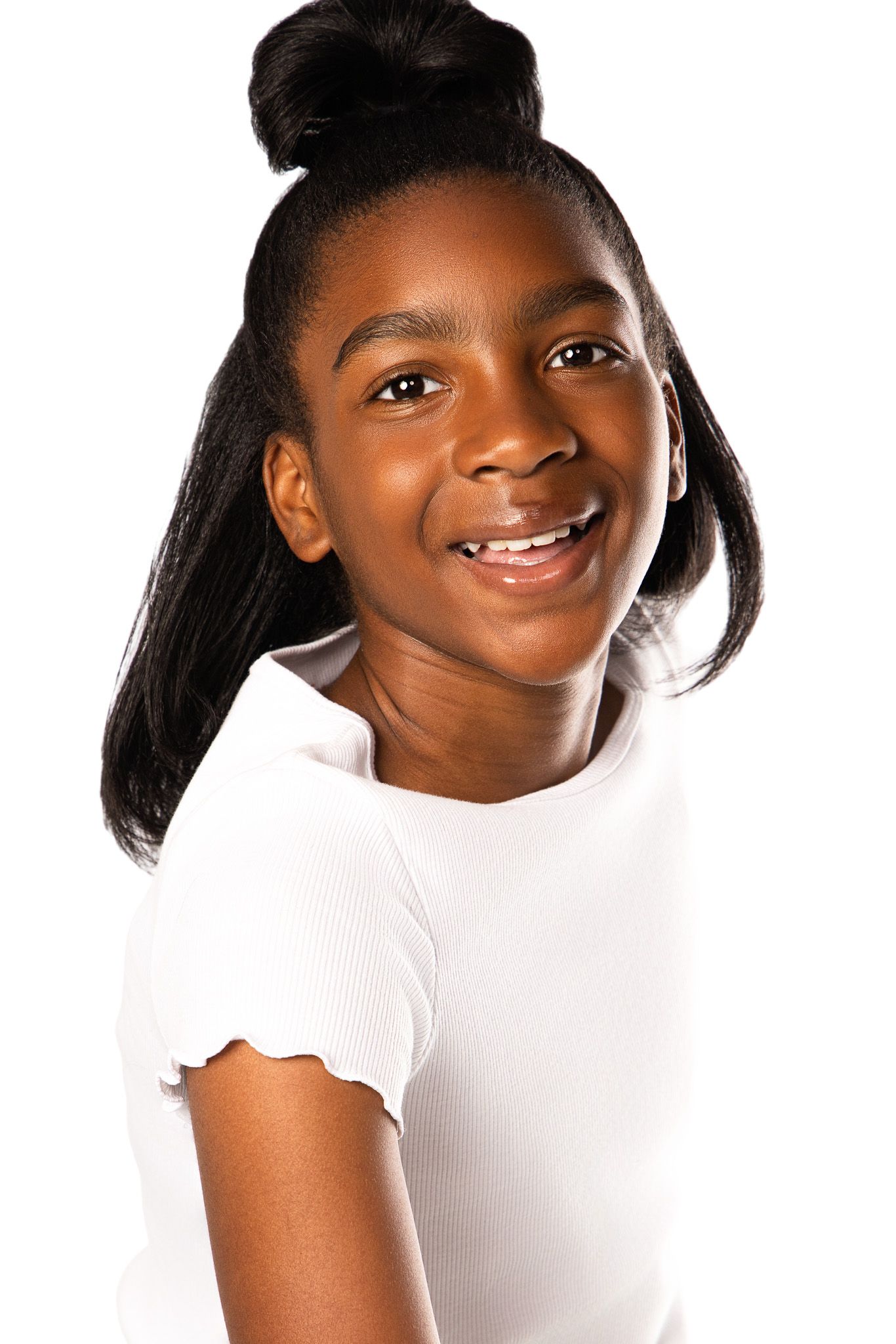 Young person wearing a white t-shirt smiles warmly against a white background.